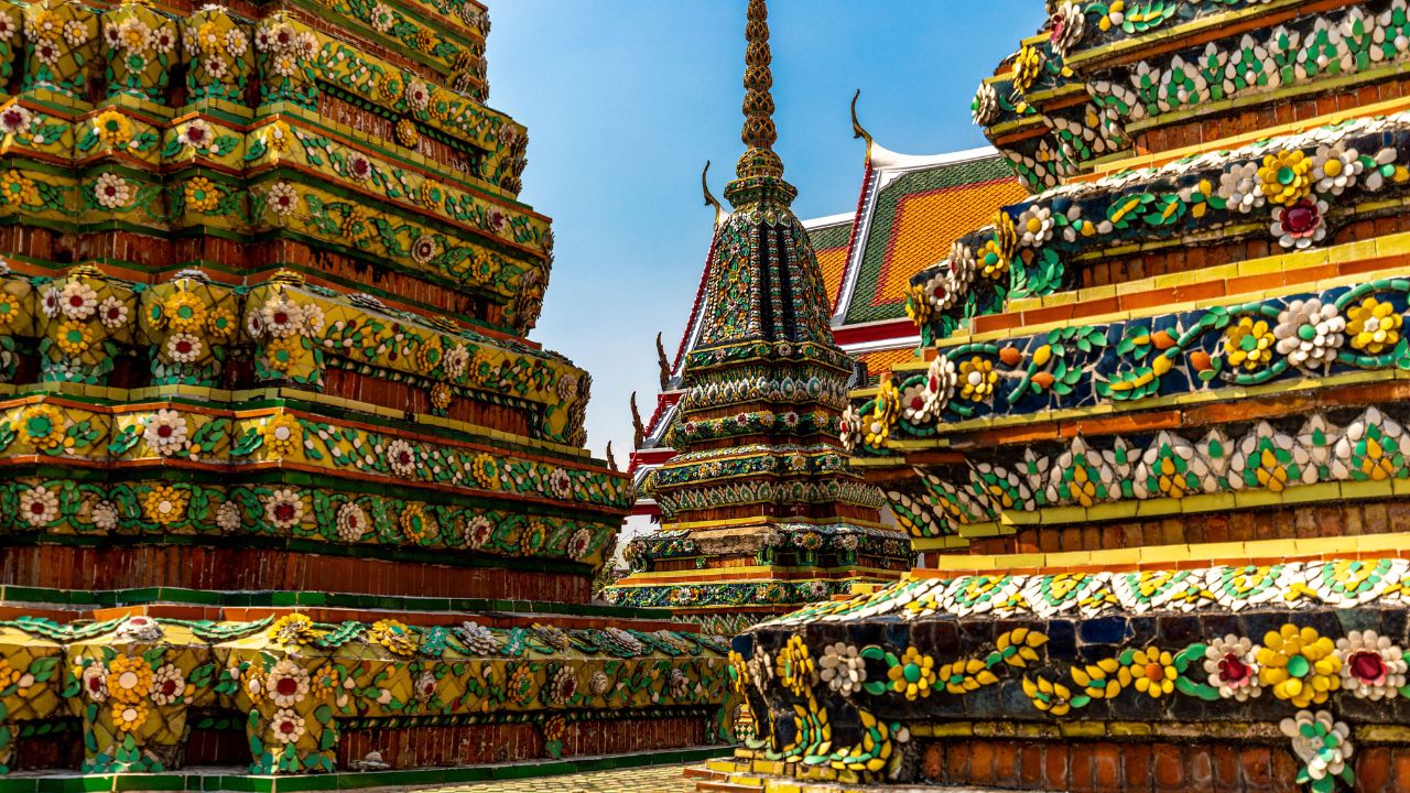 Wat Pho Bangkok guide 2026 — Reclining Buddha 46m gold leaf four royal chedis stone tablets UNESCO massage school